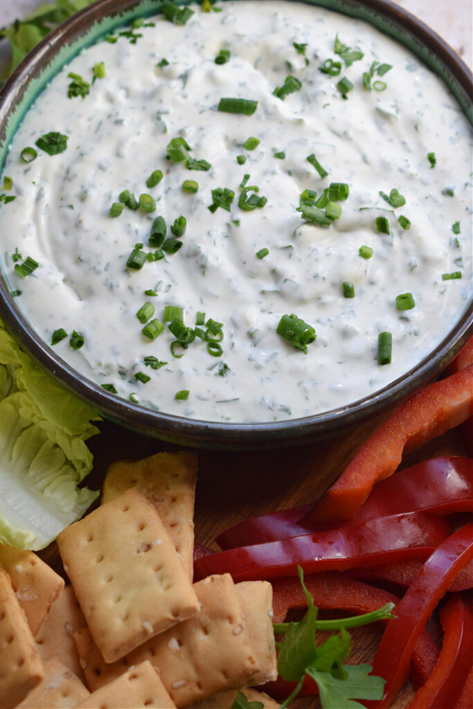 Ranch dip in a bowl with vegetables.