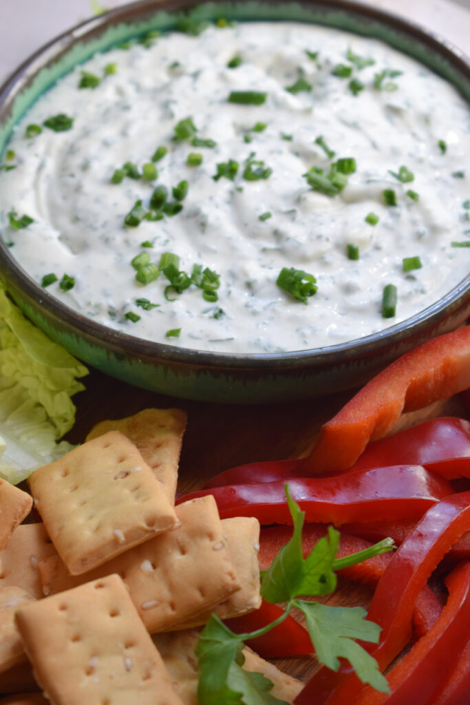 Ranch dip with bell peppers and crackers.