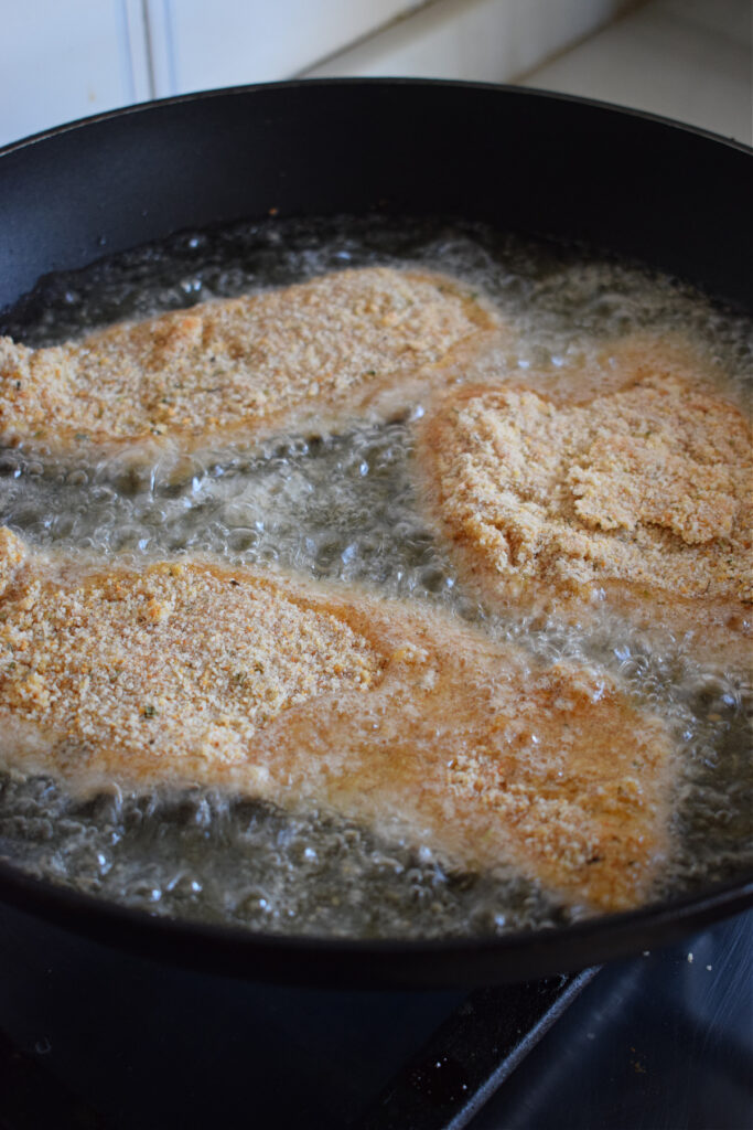 Frying chicken in a skillet.