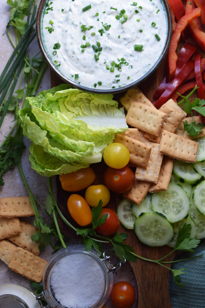 Ranch dip in a bowl with fresh cut vegetables.
