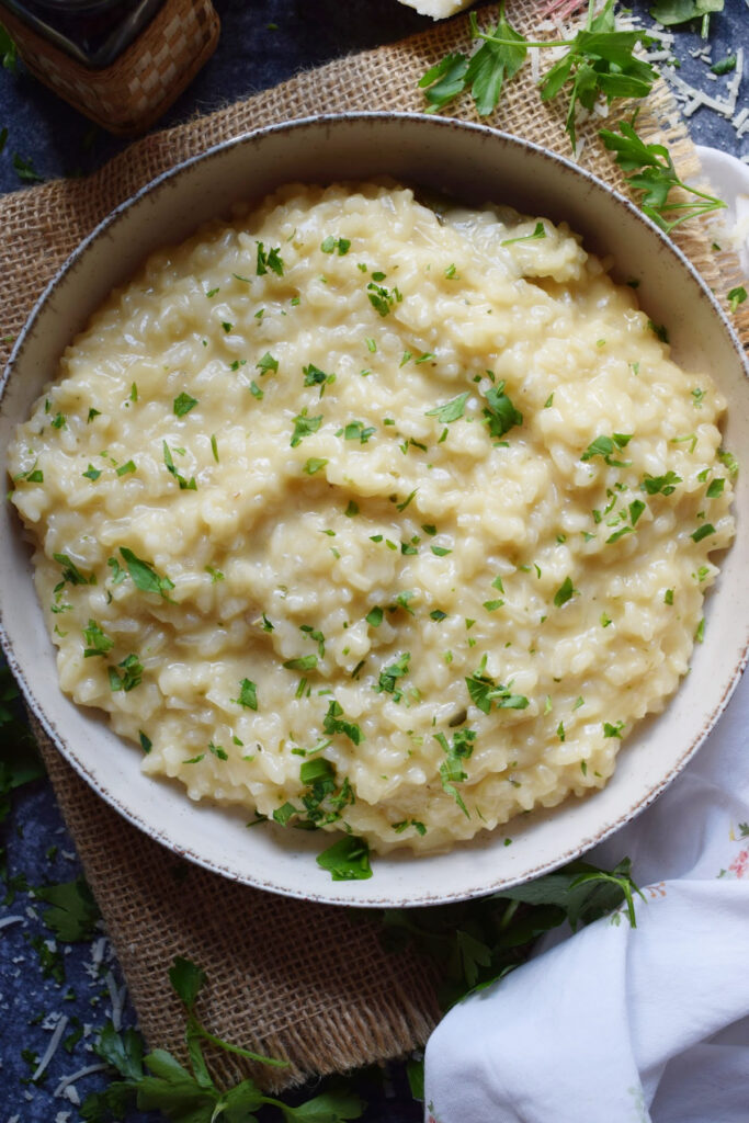 Creamy rice with parmesan cheese in a bowl.