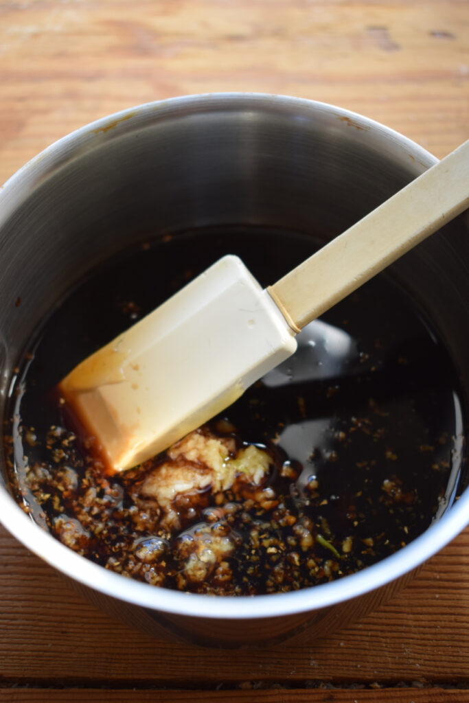 Making teriyaki sauce in a saucepan.