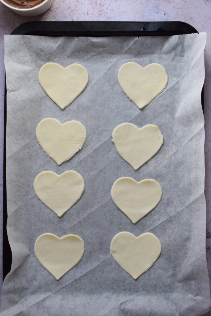 Pastry hearts on a pastry tray.