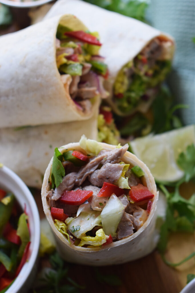 Close up of a beef and vegetable wrap.