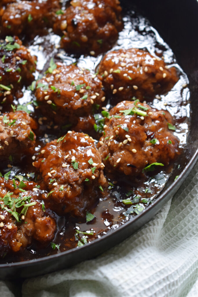 Close up of meatballs in a saucepan.