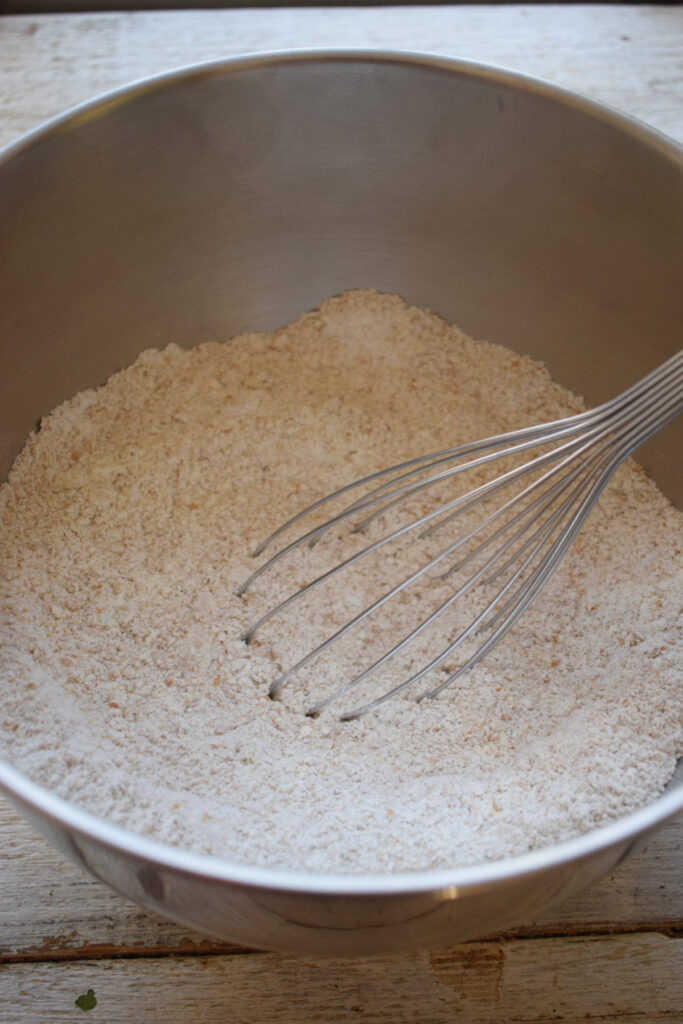Combining dry ingredients in a bowl.