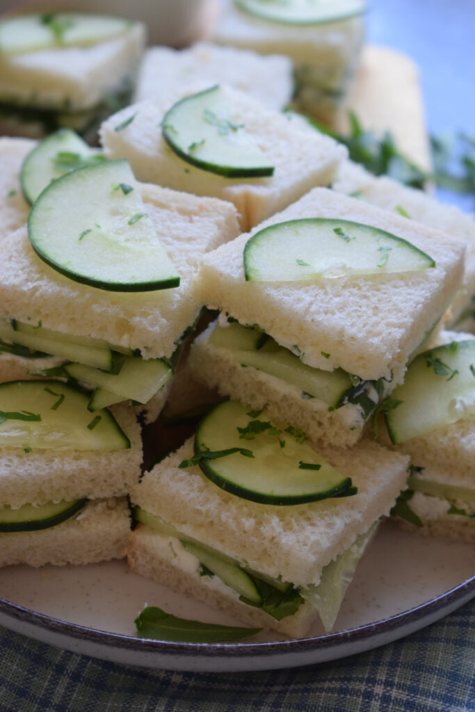 Close up of cucumber sandwiches on a plate.