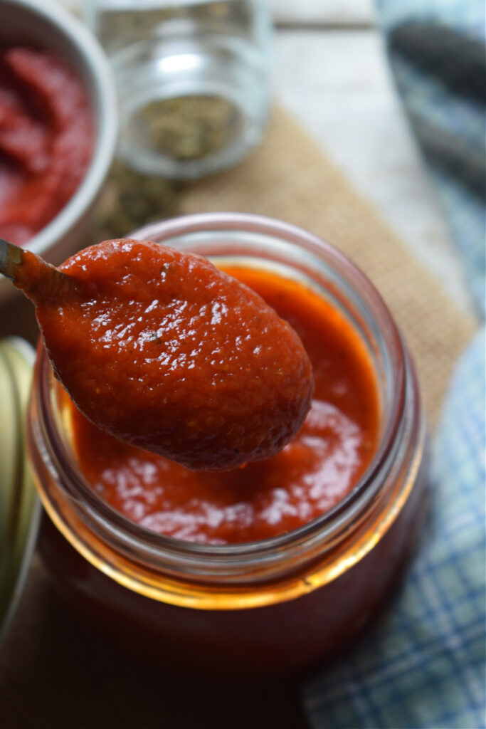 Pizza sauce on a spoon.