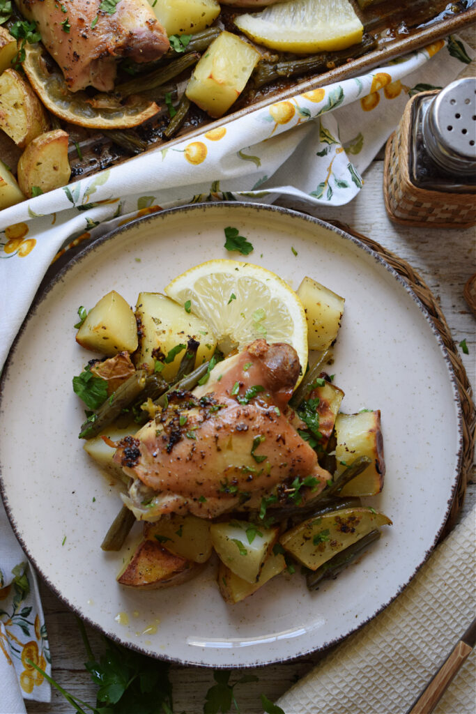 Lemon chicken on a plate with potatoes.