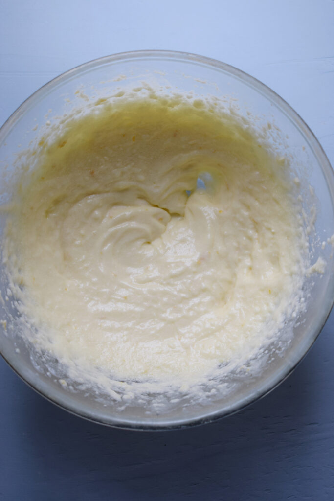 Whipped butter, sugar and ricotta cheese in a bowl.