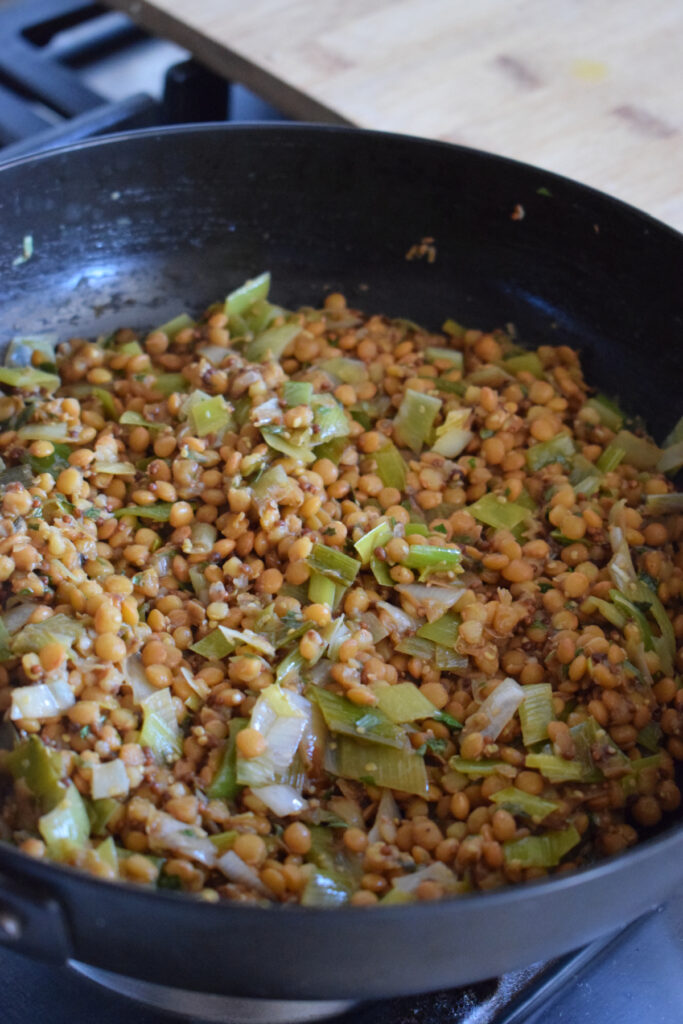 Cooked lentils in a skillet.