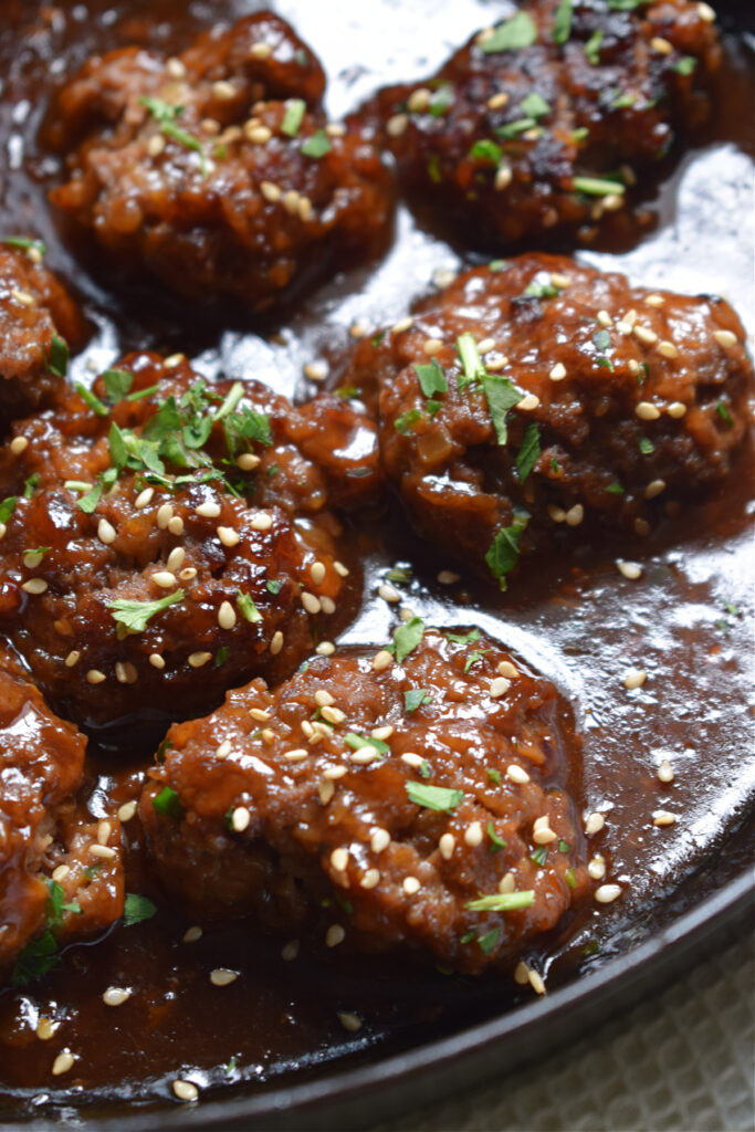 Close up of meatballs in sauce.