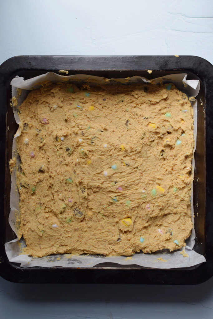 Cookie dough pressed into a baking pan.
