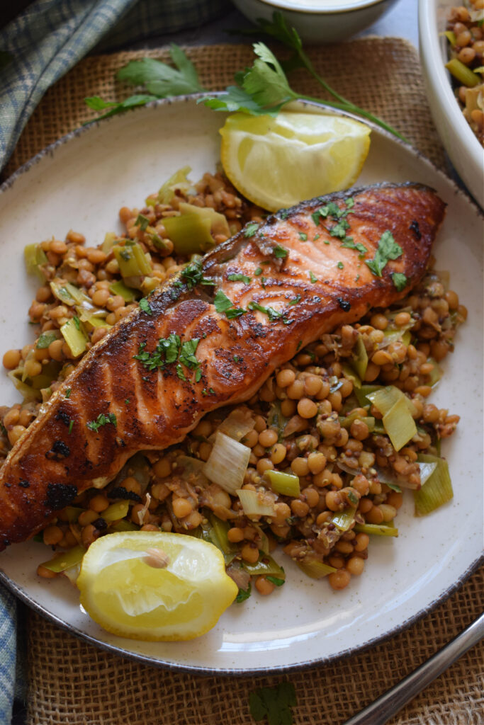 Salmon and lentils on a plate with lemon.