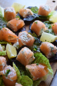 Smoked salmon on lettuce leaves with lemon.