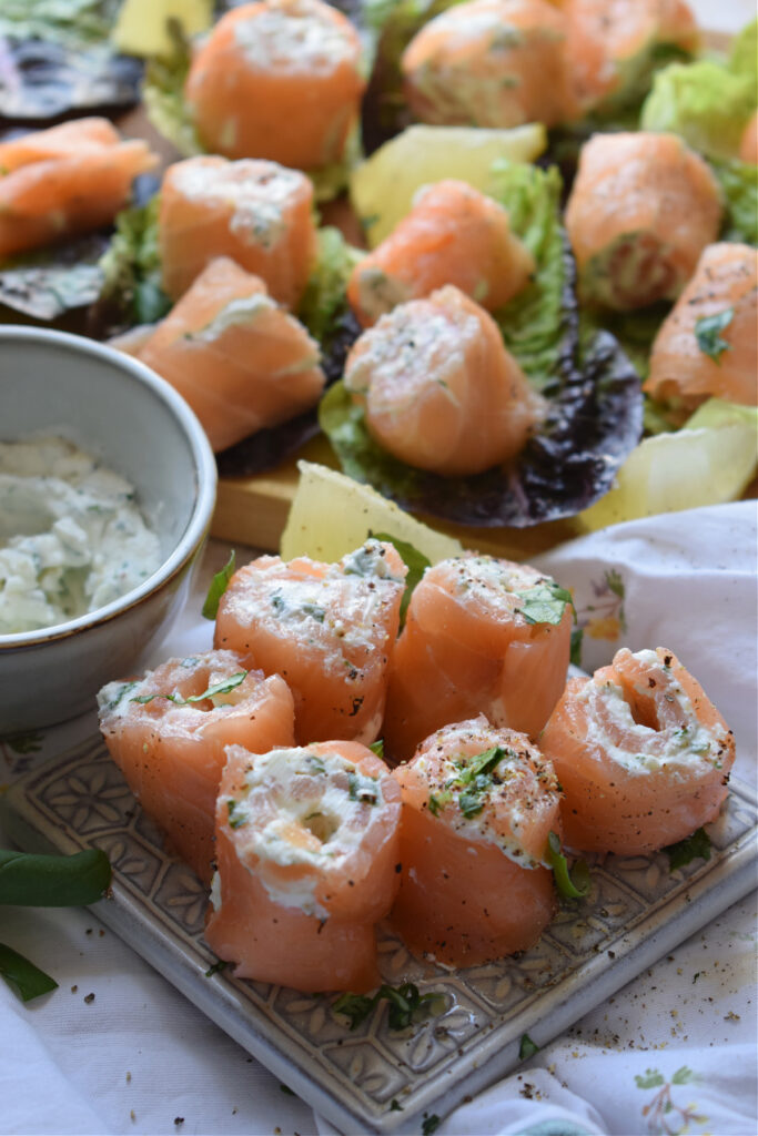 Smoked salmon appetizers on a plate.