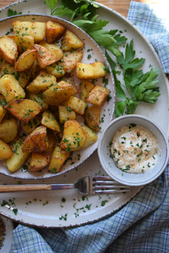Crisp potatoes with a dipping sauce and a fork.