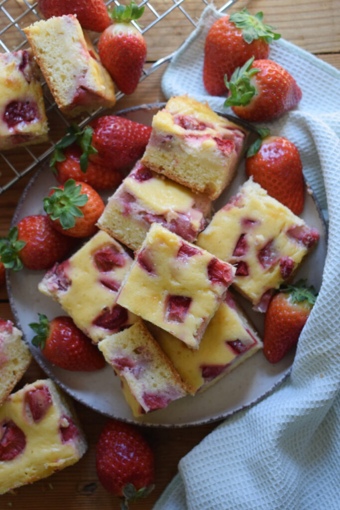 Strawberry cream cheese cake squares on a plate.