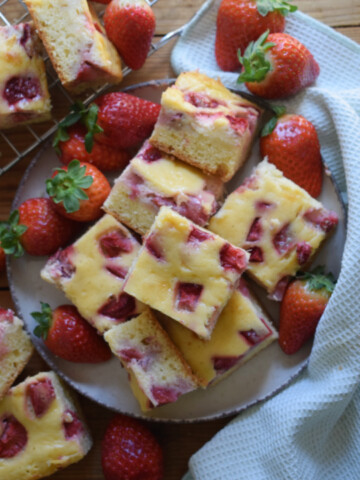 Strawberry cream cheese cake squares on a plate.