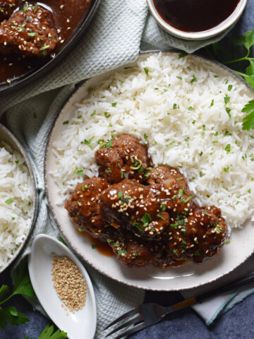 Meatballs on a plate with rice.
