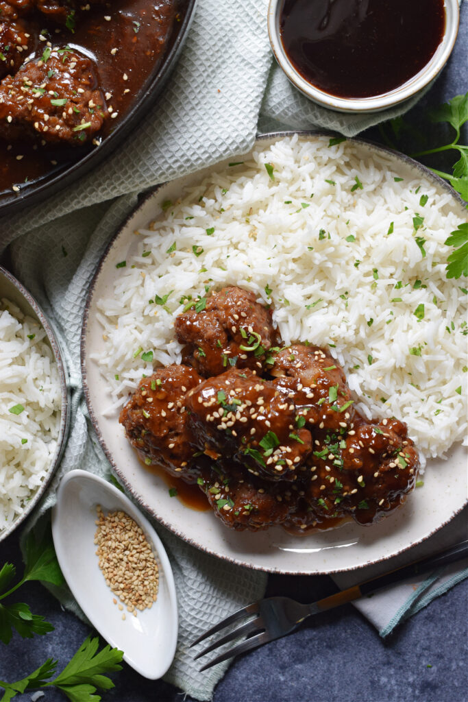 Meatballs on a plate with rice.