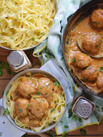 Noodles in a bowl and meatballs in a bowl.