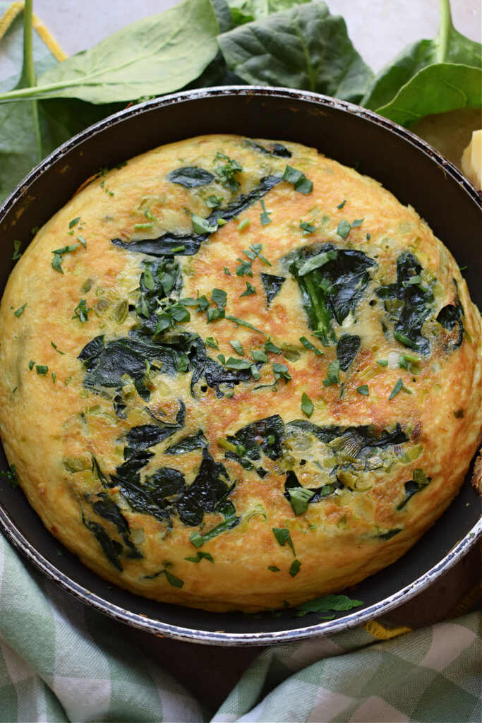 Cooked spinach frittata in a skillet.