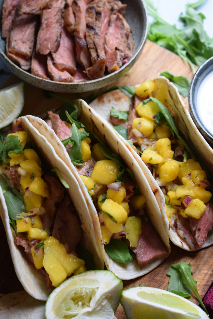 Close up of steak and mango tacos.