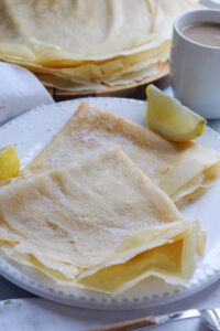 Crepes on a plate with lemon.