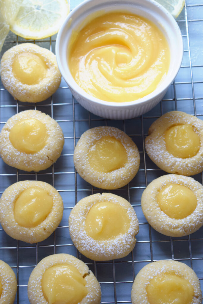 Lemon cookies on a tray with lemon curd.