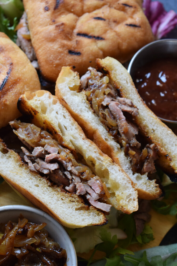 Close up of steak sandwiches with cheese.