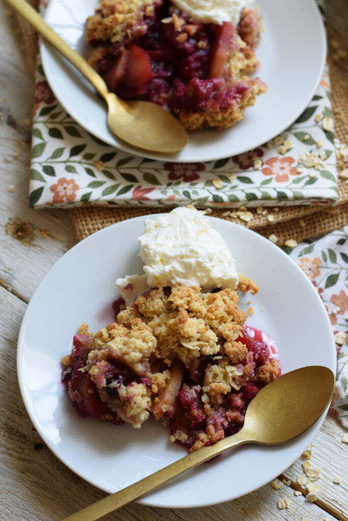 Two plates of mixed berry and apple crisp.