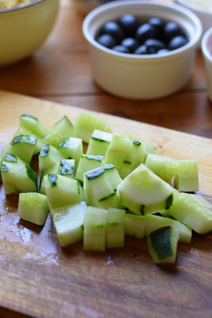 Diced cucumbers on a wooden board.
