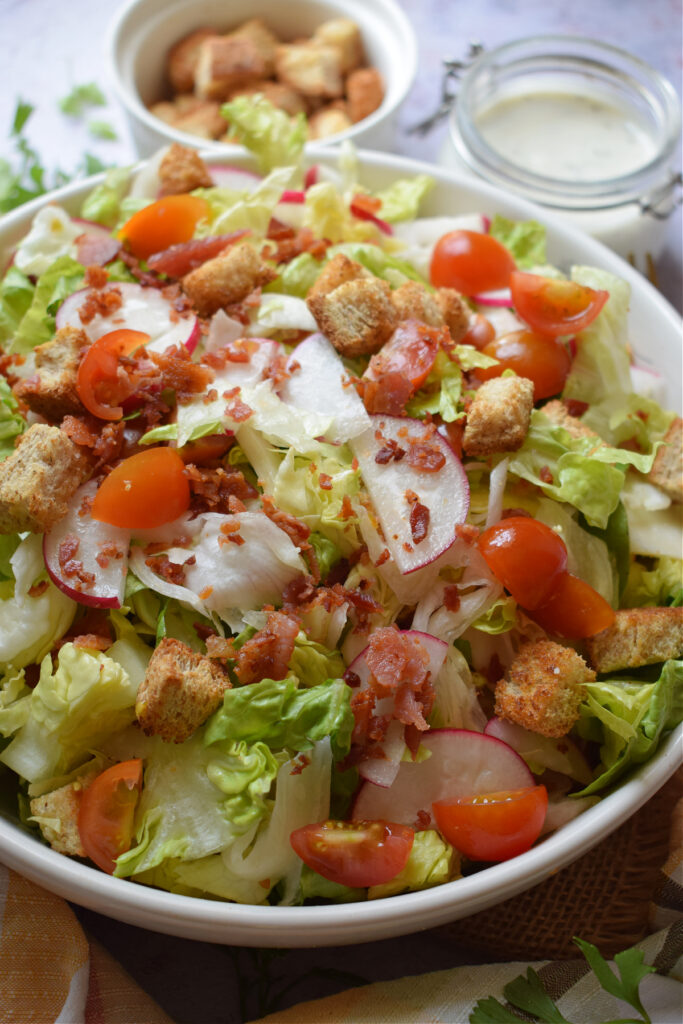 Close up of a summer bacon and tomato salad.