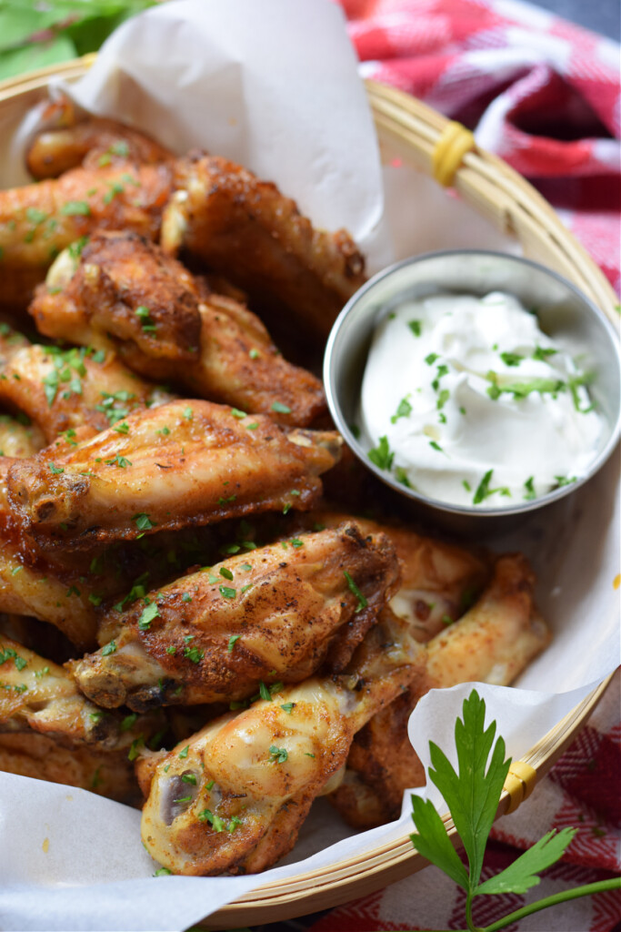 Close up of chicken wings with dip.