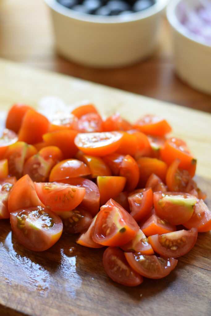 Diced tomatoes on a wooden board.
