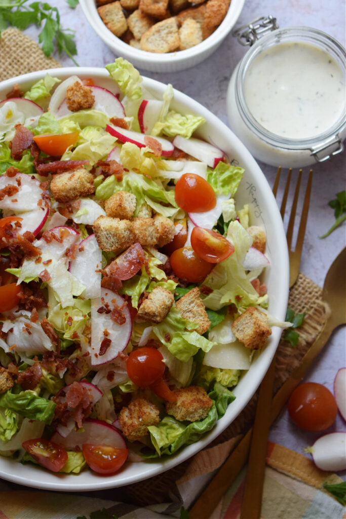 Summer salad with bacon and tomato in a salad bowl.