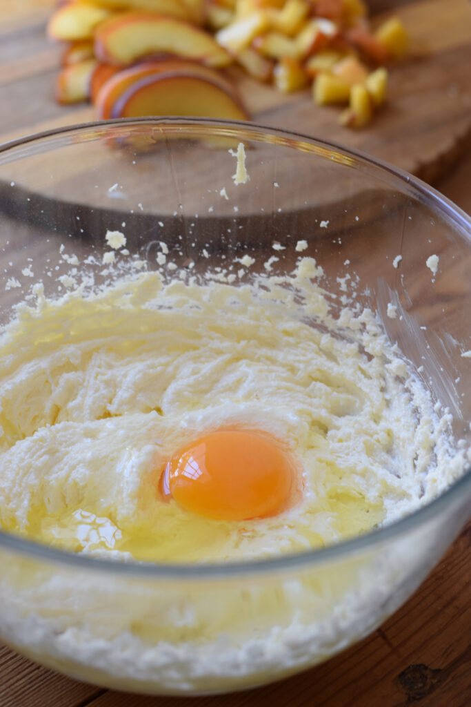 Adding eggs to cake batter.