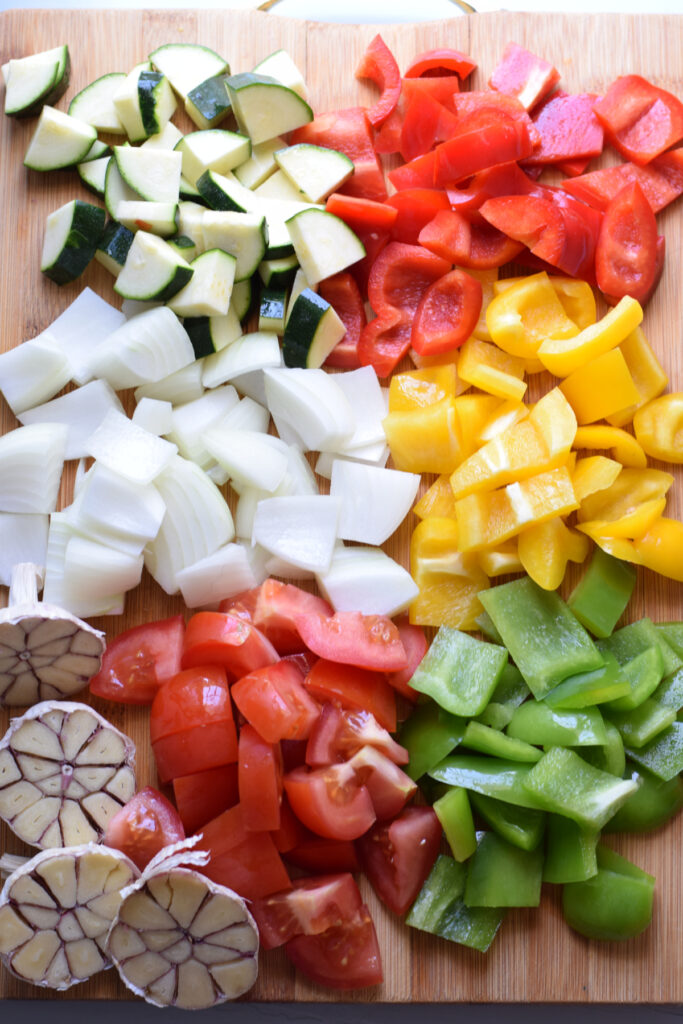 Diced vegetables on a wooden cutting board.