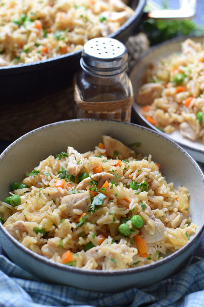 Close up of chicken and rice in a bowl.