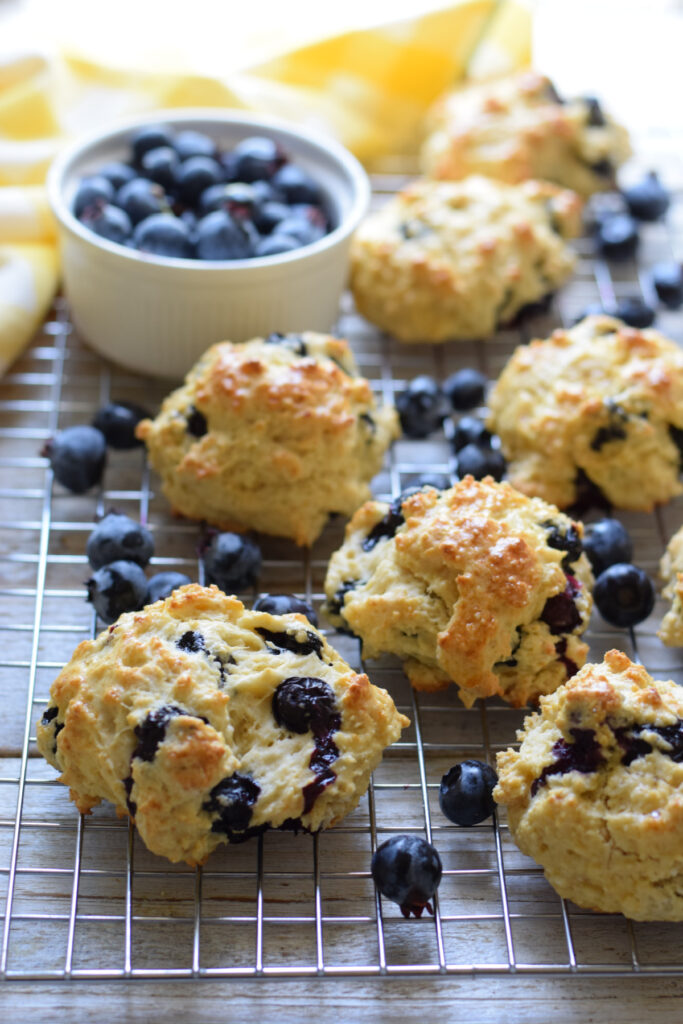 Scones with blueberries on a baking tray.