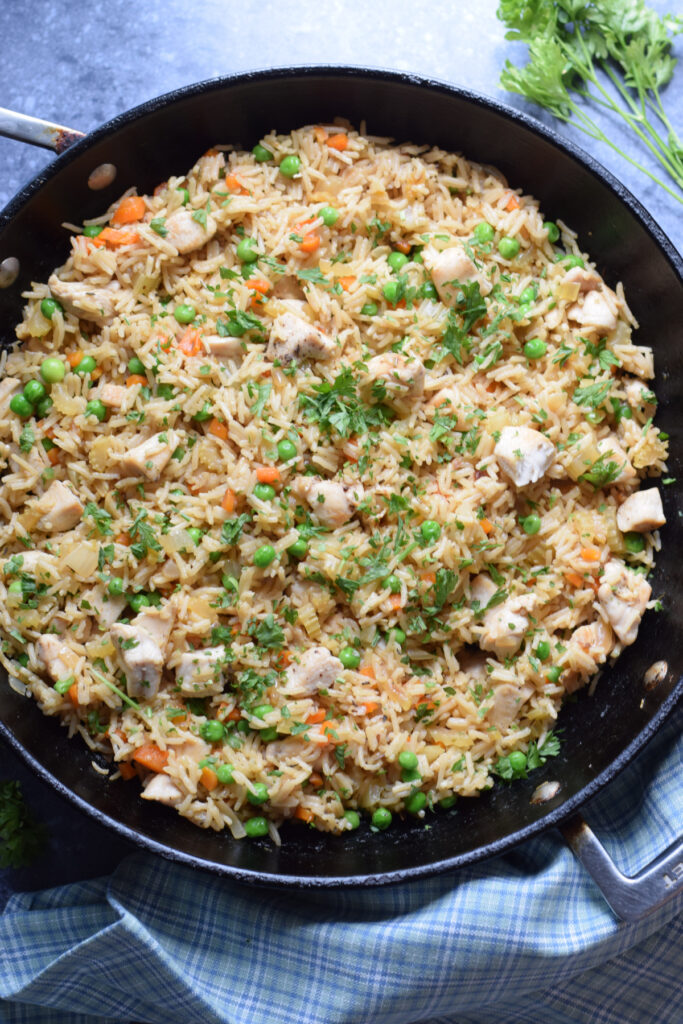 Chicken and rice dinner in a skillet.