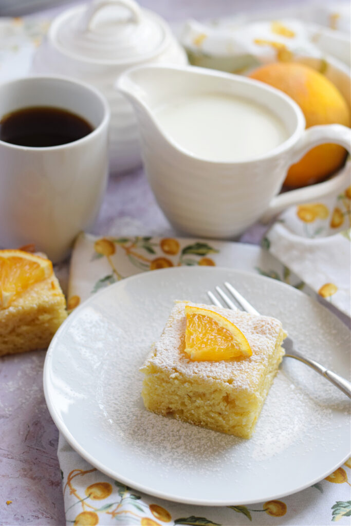 Orange cake square on a plate.