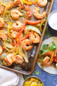 Peppers and shrimp on a baking tray.
