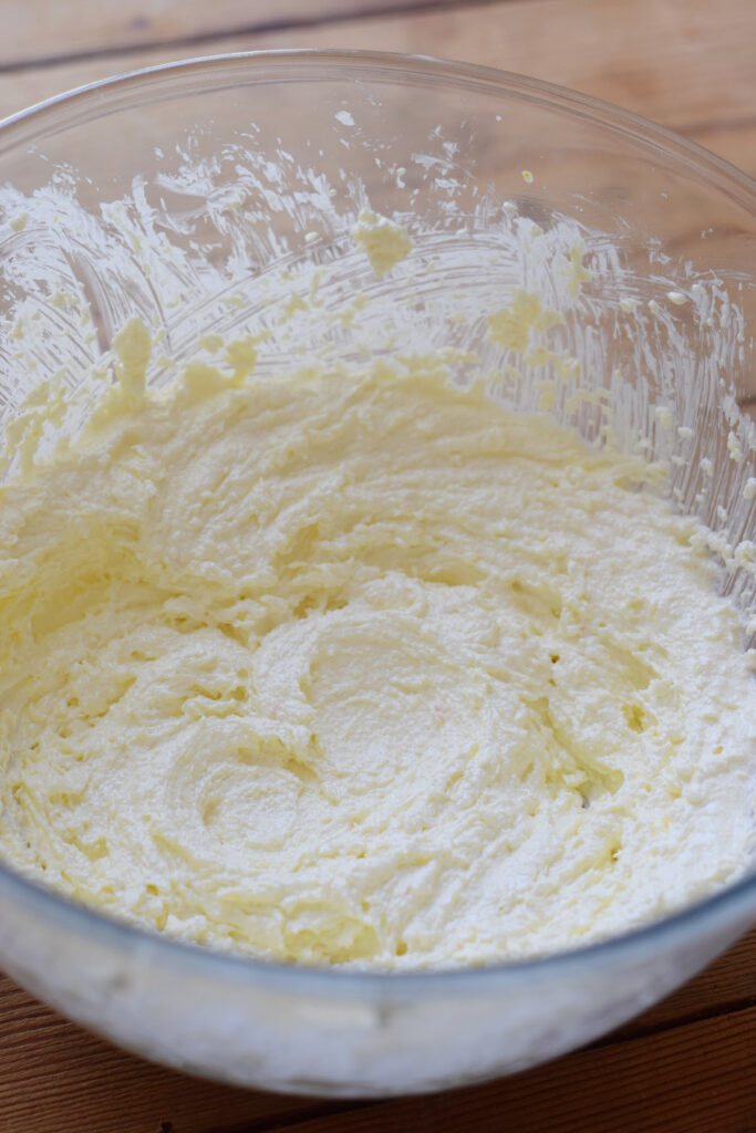 Creamed butter and sugar in a glass bowl.