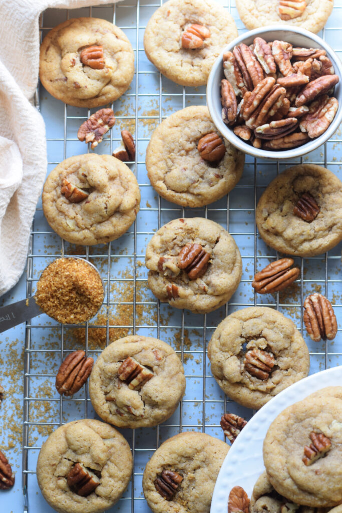 Cookies on a cookie tray with pecans.