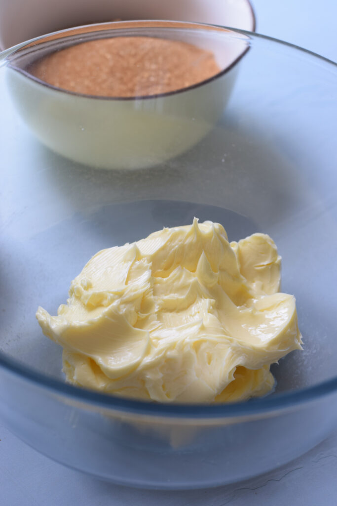 Butter in a glass mixing bowl.