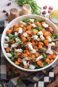 Close up of a sweet potato salad in a white bowl.