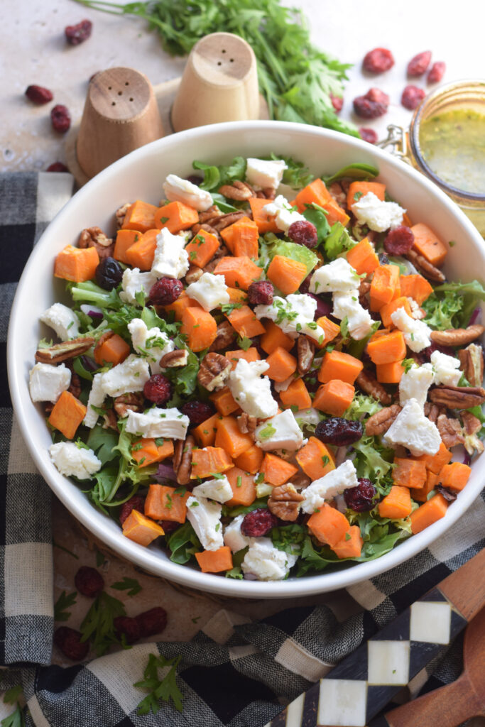 Close up of a sweet potato salad in a white bowl.