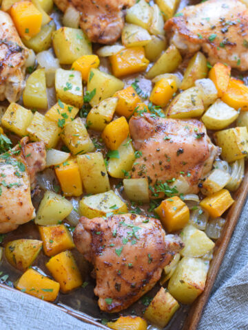 Old Bay sheet pan chicken and squash on a baking tray.
